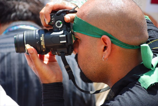 Photographer takes photos of Iranians in Texas taking part in a Freedom for Iran / Green Revolution rally at Dallas City Hall plaza in downtown Dallas, TX ca. June 2009