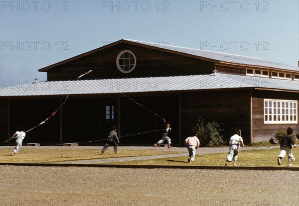 Boys flying a kite in front of community center