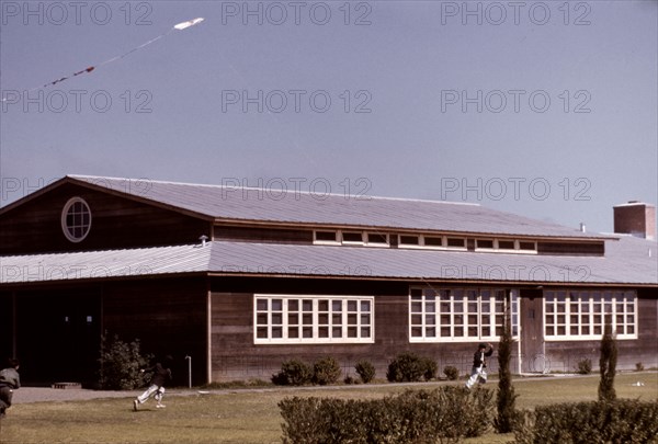 Boys flying a kite in front of the community center