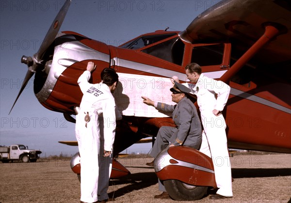 Instructor and students studying a map