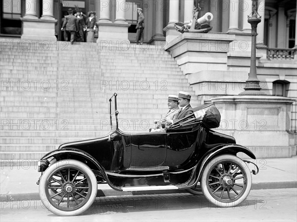 Two men in a new automobile