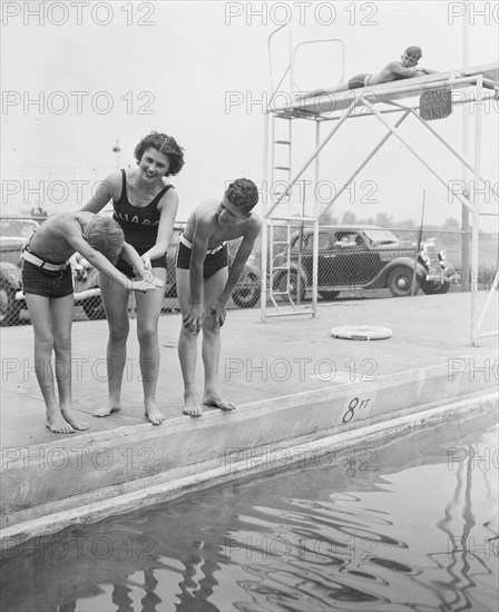 Woman and children at swimming pool