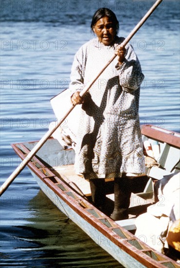 Eskimo woman tending fish nets along Kobuk River near the village of Ambler Kobuk Valley National Park, Alaska ca. 1975