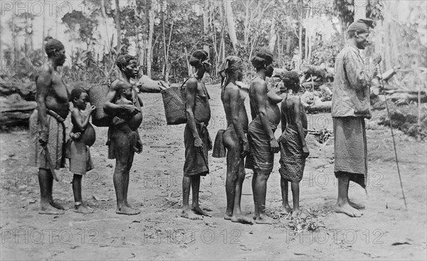 Chief from West Africa and some of his women (brides) escorting a new bride ca. 1910-1915