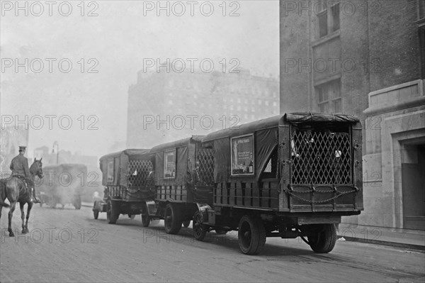 Photograph shows American Express trucks transporting gold shipped by Great Britain to New York City for safe-keeping during World War I ca. September 8, 1915