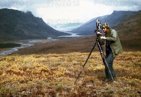 Cameraman filiming at Gates of the Arctic, Alaska ca. 1975