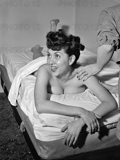 Portrait of Gloria King receiving a massage ca. Apr. 1947