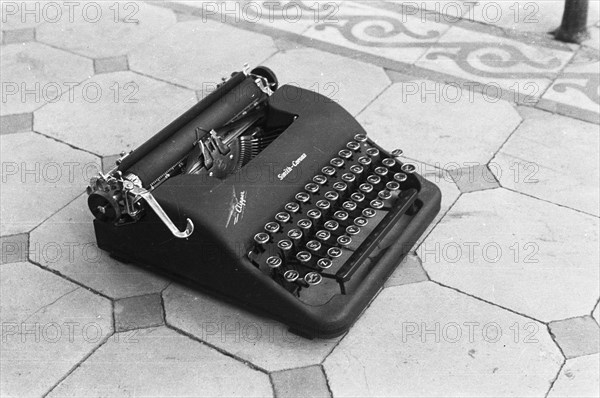 A typewriter on a tile floor; Brand Smith Corona; Date May 1947 Location Indonesia, Dutch East Indies