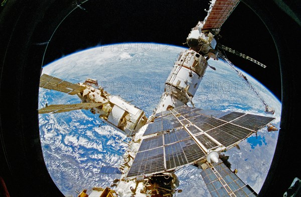 View of Mir Space Station as seen from flight deck overhead window and Spacehab