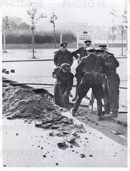 Date - Possibly August 1961 - East German Police Tear Up Pavement Near Potsdamerplatz to Build Permanent Road Block. Communist Erected Sign In Background Reads: 'You Are Entering Democratic Berlin.'