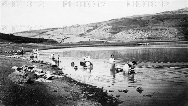 italy, women washing clothes in the river