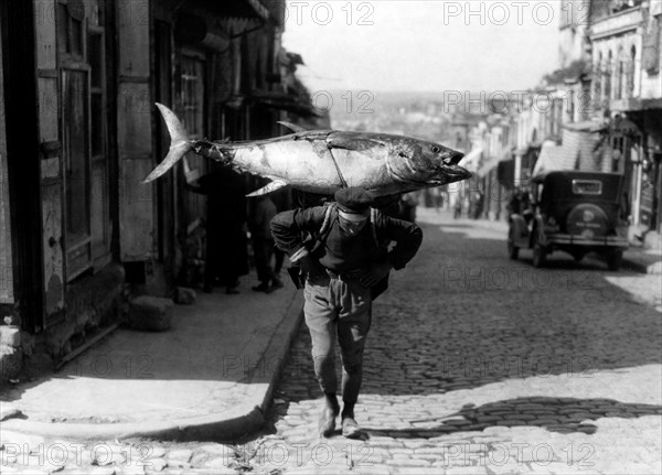 A Turkish fisherman returns with his booty. 1920-30