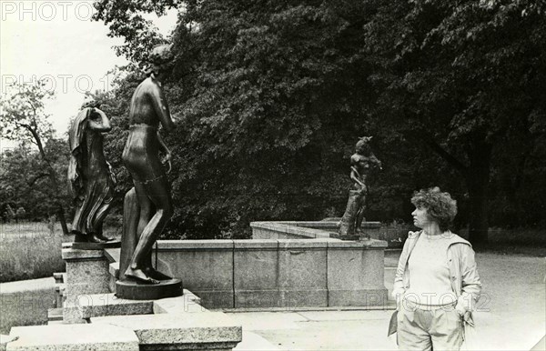 A young woman considering a sculpture park at Peterhof.