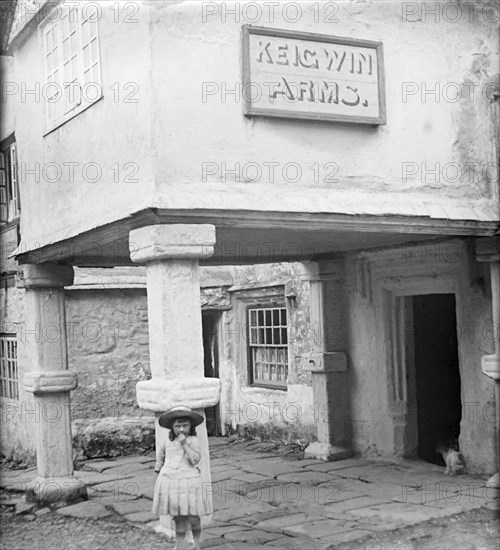 A young girl standing in front of Keigwin Arms Hotel.