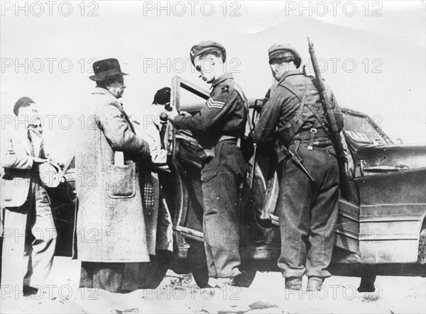 The British military stops cars on the roads in Palestine, to search them and check the identity of the passengers.