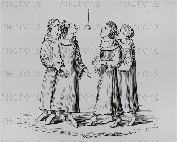 Medieval monks playing the game of bob apple or swinging apple. The apple was hung on a rope and the players had to bite them without using their arms or hands. Engraving from a 14th-century manuscript. ""Moeurs, usages et costumes au moyen-age et a l'epoque de la Renaissance"", by Paul Lacroix. Paris, 1878.