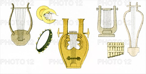 The illustration here shows ancient Greek musical instruments, inclding lyres, cymbals, a tambourine, and pan pipes. The illustration dates to 1882.