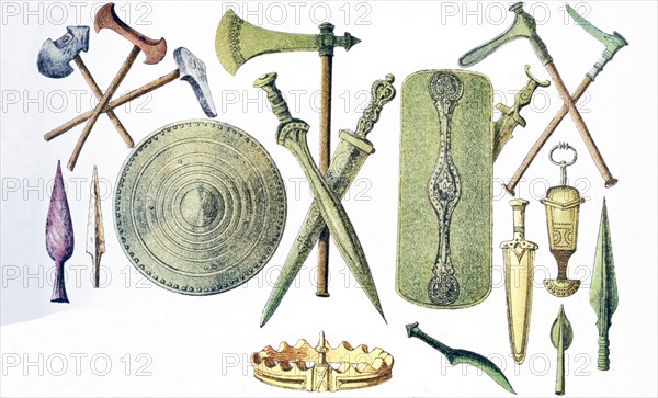 The objects pictured, from left to right and top to bottom, are from ancient European times: stone hammers, stone head of lances, metal axe, two swords, two shields, two metal hammers, three daggers, crown, knife, two heads of weapons.