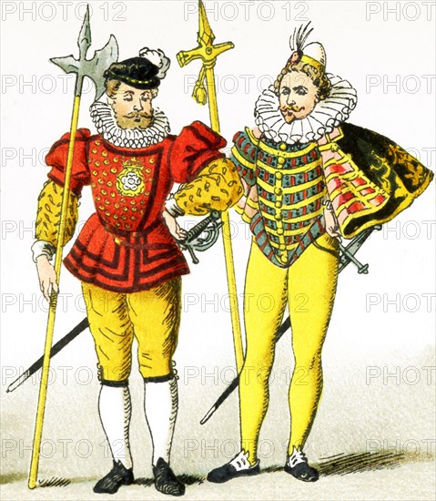 The two figures in this image are English guards from the period A.D. 1550 to 1600. They are halberdiers, as the weapon they carry is a halberd, which has an axlike blade and a steel spike mounted on the end of a long shaft. This illustration dates to 1882.