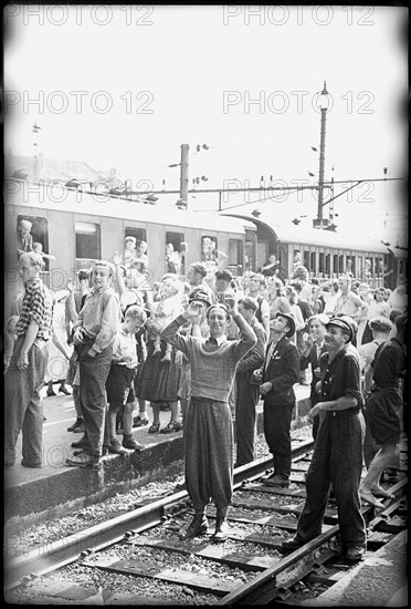 After World War 2: Swiss people cheering at POWs - presumably Italians - going home, 1946.