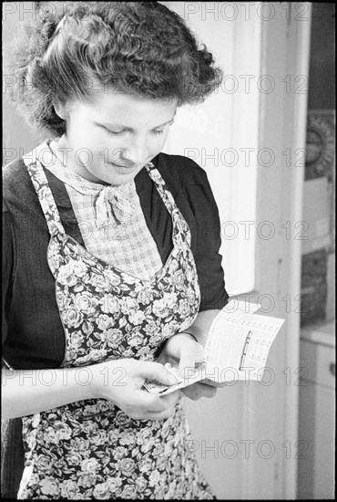 Rationing; woman; coupons to buy food; around 1943; around 1943.