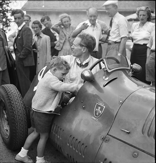 Emmanuel de Graffenried and son Leo in racing car, 1950.