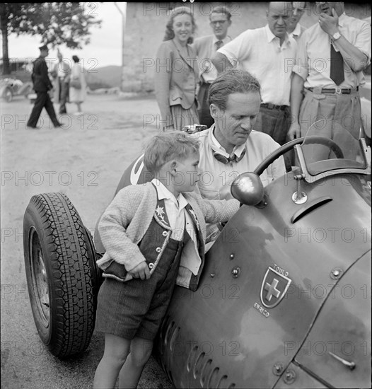 Emmanuel de Graffenried and son Leo in racing car, 1950.