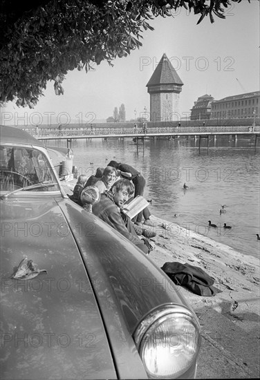 Lucerne, young people sitting at riverbank; 1967.