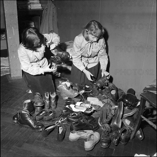 Basel girl scouts sorting clothing for Hungary 1956.