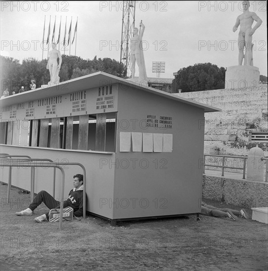 Rome 1960: greek athlete leaning against calling room.