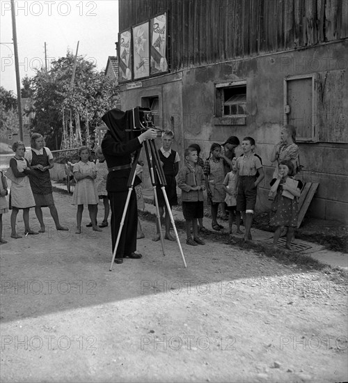 WW 2: bombing in Switzerland; police photographer documenting damage, Dozwil.