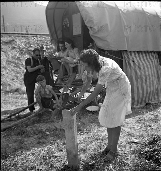 Yenish woman chipping wood, 1943