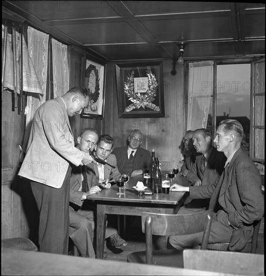 Marksman Heinz Ambuehl demonstrates his skill to his customers; Zell ca. 1948.