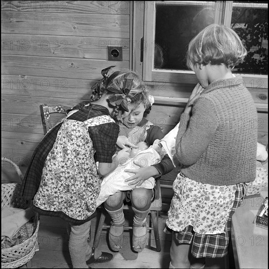 Girls playing with a baby doll at Pestalozzi Village, Trogen 1952.