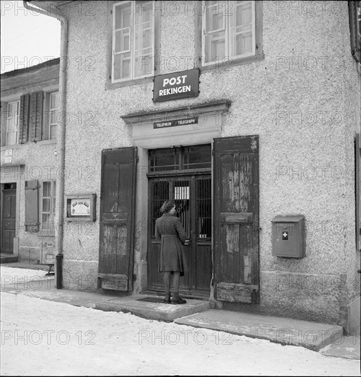 Woman in front of the post office in Rekingen AG 1950.