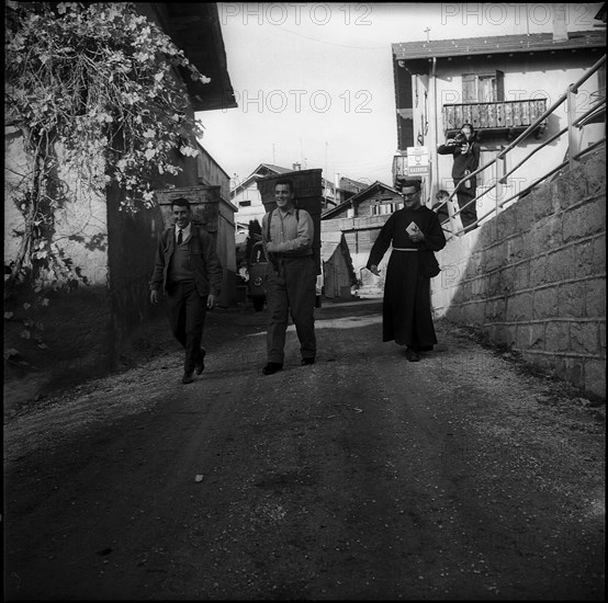 Capuchin monks collecting Communion wine in the Valais, 1967