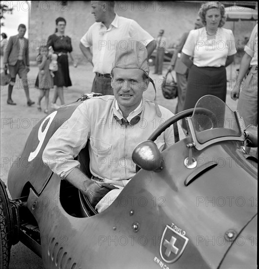 Emmanuel de Graffenried and son in racing car, 1950