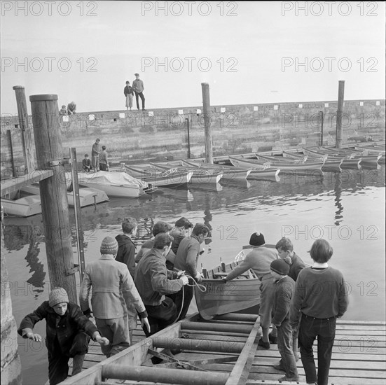 Boys launching a boat, Rorschach harbour 1958