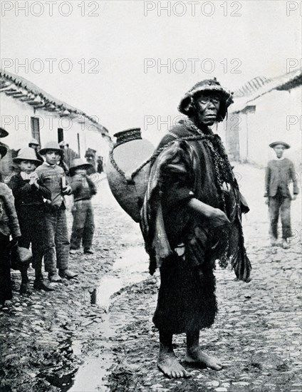 This photograph, dating to 1914 or earlier, shows an Indian water carrier in Sicuani, a town in southern Peru, capital of Canchis Province in Cusco Region.