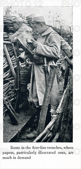 The caption for this photo that dates to between 1914 and 1917 (time of the First World War) reads: Scene in the first-line trenches, where papers, particularly illustrated ones, are much in demand.