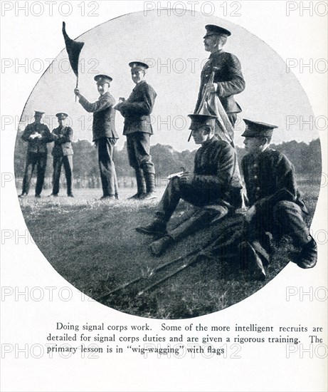 This photo taken in Europe in World War I has as its caption: Doing signal corps work. Some of the more intelligent recruits are detailed for signal corps duties and are given a rigorous training. The primary lesss in 'wig-wagging' with flags. The name 'wig-wagging' reflects the concept of back and forth movement as a means of signaling through motion.