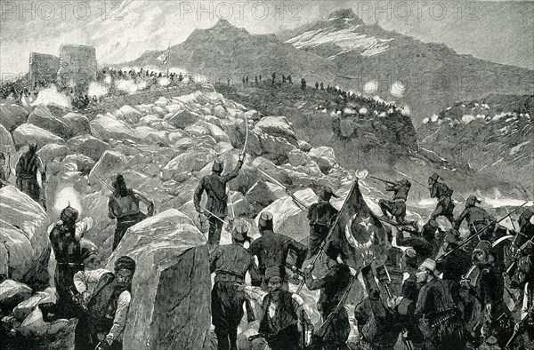 The early 1900s caption reads: Turkish Troops Attack Cretan Insurgents. During the Cretan Insurrection of 1896, the Christians of Crete were obliged to retire to the mountains to escape the massacre by the Turkish troops. When, however, they were pursued into their wild retreats, they defeated the troops repeatedly. A glance at the picture will show you how impossible it was for the Turks to drive resolute men from these picturesque fortresses, amid rock and cliff.