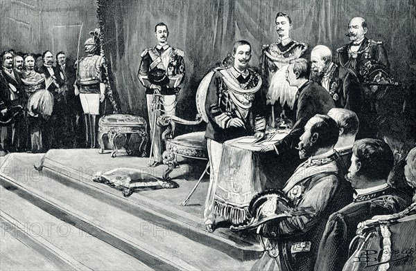 The 1906 caption reads: “Victor Emmanuel III Taking the Oath of Office. Victor Emmanuel III, king of Italy, took the oath of office August 11, 1900. His father had been assassinated nearly two weeks before; but the prince had been at sea in his yacht; and took some time to find him and arrange matters. He signed the oath in the presence of the chief parliamentary officers, judges, and generals of the land, while a brilliant assembly of all Italy’s leading men filled the great hall below the raised dais prepared for the throne.”.