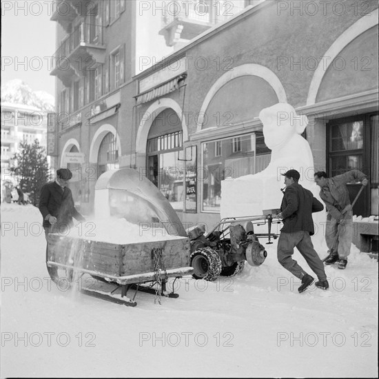 Davos; men clearing snow; 1951.