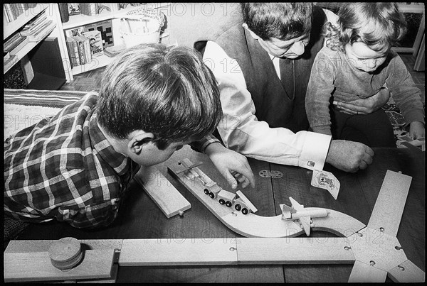 Father playing with his children, 1967.