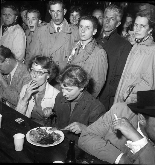 Zurich Festival 1953; woman in front of a plate at table.