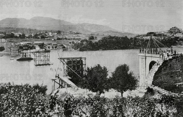 History of Spain. Galicia. Province of Pontevedra. Tui International Bridge over the Mino river. It was designed by the engineer Pelayo Mancebo y Agreda (1845-1912). Construction work began in 1884, and it was officially opened on 25 March 1886. It provided a connection between the towns of Tui (Spain) and Valenca do Mino (Portugal). State of the masonry works at the start of the foundation of the pillars. Engraving by Bernardo Rico. La Ilustracion Espanola y Americana (The Spanish and American Illustration), March 8, 1884.