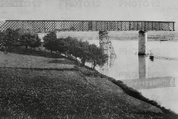 History of Spain. Galicia. Province of Pontevedra. Tui International Bridge over the Mino river. It was designed by the engineer Pelayo Mancebo y Agreda (1845-1912). Construction work began in 1884, and it was officially opened on 25 March 1886. It provided a connection between the towns of Tui (Spain) and Valenca do Mino (Portugal). State of the works in February 1884, after the installation of three metal sections, of the total of five that would make it up. Engraving by Tomas Carlos Capuz (1834-1899). La Ilustracion Espanola y Americana (The Spanish and American Illustration), March 8, 1884.