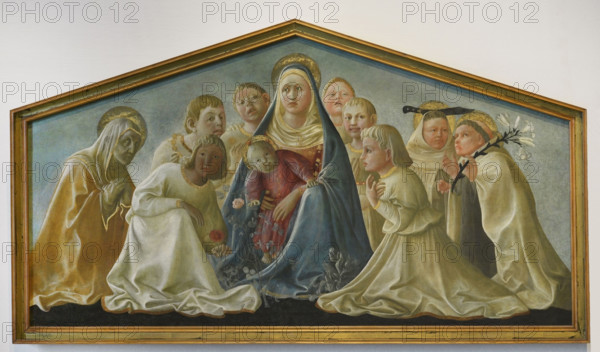 Filippo Lippi (1406-1469). Italian painter. Madonna with Child, saints and angels, known as ""Madonna Trivulzio"", 1429-1432. The angels seated next to the Virgin are depicted without wings and among them we can identify some saints of the Carmelite order; from left: Angela of Bohemia (veiled hands), Angelo of Licata (with a knife), and Alberto of Sicily (with a lily). Tempera on wooden panel transferred to canvas (62 x 167,5 cm). Pinacoteca Castello Sforzesco, Milan, Italy.