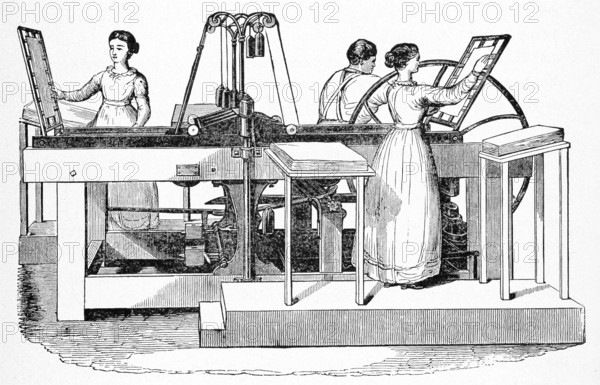 In this 1901 illustration of a Frances Adams bookpress, two women and a man are shown using a screw press made of wood and metal gears to bind and rebind books.